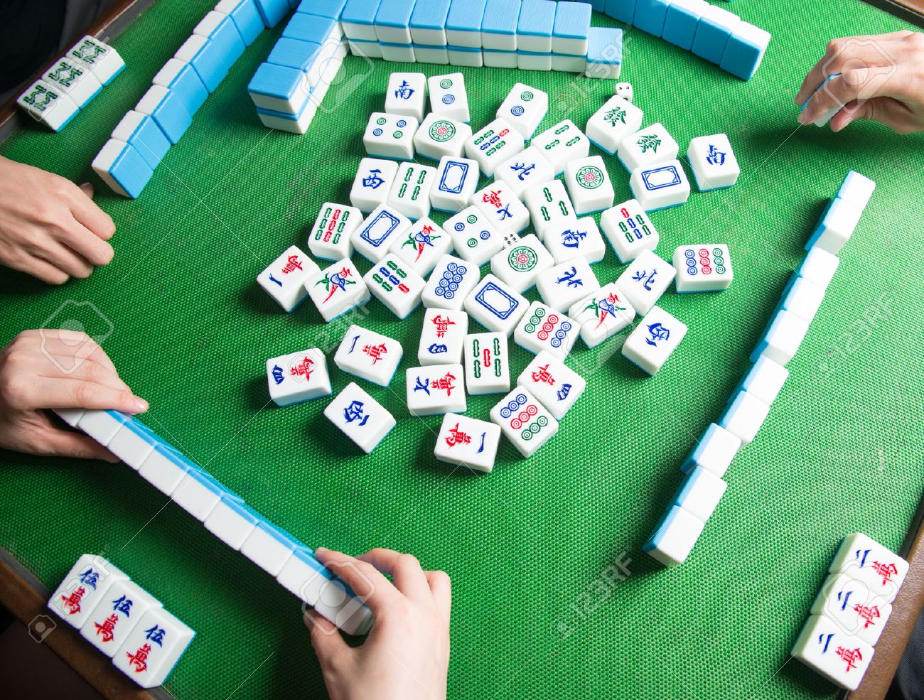 24227708-people-playing-mahjong-game