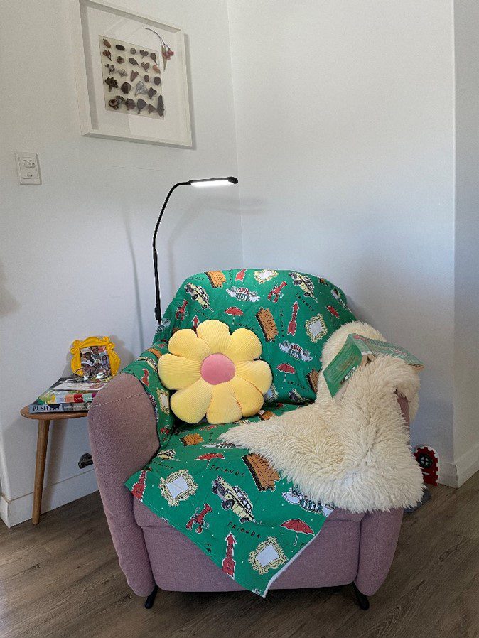 Photograph of reading chair with cushions and blankets Photograph of reading chair with cushions and blankets